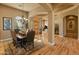 A view of the dining room with chandelier leading to the foyer and piano room at 27561 N 84Th Dr, Peoria, AZ 85383