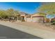 Exterior of home with three-car garage and desert landscaping at 27561 N 84Th Dr, Peoria, AZ 85383