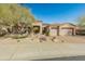 Exterior of home with three-car garage and desert landscaping at 27561 N 84Th Dr, Peoria, AZ 85383