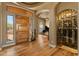 Entryway featuring a wooden door, wine cellar and leading to piano room at 27561 N 84Th Dr, Peoria, AZ 85383