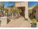 Home entrance with a wooden door, bench, and desert landscaping at 27561 N 84Th Dr, Peoria, AZ 85383