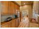 Hallway boasts custom cabinetry, hardwood floors, a built-in bench, and elegant decor at 27561 N 84Th Dr, Peoria, AZ 85383