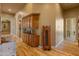 Hallway features wood floors, arched doorways, and custom cabinetry, and a built-in buffet at 27561 N 84Th Dr, Peoria, AZ 85383