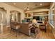 Inviting living room with a stone fireplace, built-in shelving, and comfortable seating at 27561 N 84Th Dr, Peoria, AZ 85383