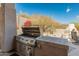 Outdoor kitchen with stainless steel grill and tiled countertop at 27561 N 84Th Dr, Peoria, AZ 85383