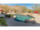 Backyard pool with stone waterfall feature, fireplace, landscaping, and mountain views at 27561 N 84Th Dr, Peoria, AZ 85383