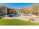 Backyard oasis featuring a pool, spa, lush lawn, and breathtaking mountain views at 27561 N 84Th Dr, Peoria, AZ 85383