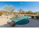 Backyard pool with stone waterfall feature and lush landscaping at 27561 N 84Th Dr, Peoria, AZ 85383