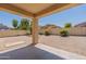 Inviting backyard with low-maintenance landscaping, a covered patio, and a block fence at 2856 N 152Nd Ln, Goodyear, AZ 85395