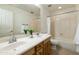 Bathroom featuring a dual sink vanity, tile floors, and shower-tub combination at 2856 N 152Nd Ln, Goodyear, AZ 85395