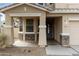 Charming home showcasing a covered front porch, stone accents, and a low-maintenance landscape at 2856 N 152Nd Ln, Goodyear, AZ 85395