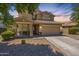 Two-story home featuring a two-car garage, desert landscaping, and a welcoming front entry way at 2856 N 152Nd Ln, Goodyear, AZ 85395