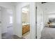 Bright hallway featuring neutral carpet, white walls, and a charming view to the bathroom and another bedroom at 2856 N 152Nd Ln, Goodyear, AZ 85395