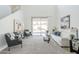 Inviting living room with high ceilings, neutral carpet, and access to the outdoor space through sliding glass doors at 2856 N 152Nd Ln, Goodyear, AZ 85395