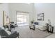 Bright living room with sliding glass doors and contemporary furniture offers relaxed elegance and indoor-outdoor flow at 2856 N 152Nd Ln, Goodyear, AZ 85395