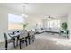 Bright living room with dining area, neutral decor, and large windows providing plenty of natural light at 2856 N 152Nd Ln, Goodyear, AZ 85395