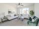 Comfortable living room featuring neutral carpet, two sofas, and a large window providing natural light at 2856 N 152Nd Ln, Goodyear, AZ 85395