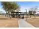 Community playground surrounded by green space featuring covered picnic areas and play structures for Gathering fun at 2856 N 152Nd Ln, Goodyear, AZ 85395