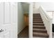 A view of carpeted staircase, with a closet underneath, leading to the upper level of the home at 2856 N 152Nd Ln, Goodyear, AZ 85395