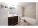 Well-lit bathroom featuring a vanity, toilet, and shower-tub combination with decorative tile at 2923 E Wahalla Ln, Phoenix, AZ 85050