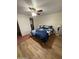 Bedroom with a ceiling fan, wood flooring, and a blue floral comforter set at 2923 E Wahalla Ln, Phoenix, AZ 85050