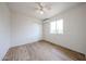 This bedroom is large, with updated flooring, a ceiling fan, and good natural light at 2923 E Wahalla Ln, Phoenix, AZ 85050