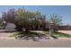Inviting home with lush landscaping, green grass, mature trees, and a brick walkway at 2923 E Wahalla Ln, Phoenix, AZ 85050