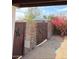 The pathway towards the guest house, marked by a star-adorned gate and lush landscaping at 2923 E Wahalla Ln, Phoenix, AZ 85050