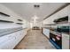 Open kitchen with white cabinets, granite countertops, and a full range of stainless steel appliances at 2923 E Wahalla Ln, Phoenix, AZ 85050