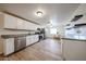 Spacious kitchen featuring white cabinets, granite countertops, and stainless steel appliances at 2923 E Wahalla Ln, Phoenix, AZ 85050