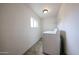 Functional laundry room with tile floors and washer/dryer hookups at 2923 E Wahalla Ln, Phoenix, AZ 85050