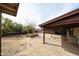 Spacious patterned concrete patio, partially covered with mature landscaping and outdoor kitchen at 2923 E Wahalla Ln, Phoenix, AZ 85050