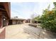Covered patio with an orange tree, leading to a rear entry door and a backyard at 2923 E Wahalla Ln, Phoenix, AZ 85050