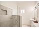 Modern bathroom featuring a glass-enclosed shower and stylish vanity with ample lighting at 2929 N 55Th Pl, Phoenix, AZ 85018