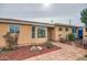 Exterior of a charming tan home with manicured landscaping and a brick walkway at 2929 N 55Th Pl, Phoenix, AZ 85018