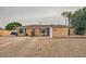 Charming single-story home with desert landscaping, large windows and attached garage at 2929 N 55Th Pl, Phoenix, AZ 85018