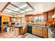 View of the kitchen, featuring terracotta tile, orange walls, wooden cabinetry, and a work station at 2929 N 55Th Pl, Phoenix, AZ 85018