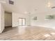 Spacious living room featuring wood-look flooring, modern lighting, and natural light from the windows at 2929 N 55Th Pl, Phoenix, AZ 85018