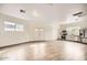 Open living space with wood-look flooring, featuring a kitchen with stainless steel appliances at 2929 N 55Th Pl, Phoenix, AZ 85018