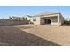 Expansive backyard featuring gravel landscaping, a covered patio, and privacy fencing at 29909 N Yucca Dr, Florence, AZ 85132