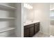 Bathroom features double sinks, large mirror, and open shelving at 29909 N Yucca Dr, Florence, AZ 85132