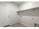 Laundry room with door and large shelf above the washing machine at 29909 N Yucca Dr, Florence, AZ 85132