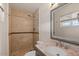 Bathroom featuring a tiled shower, granite countertop, and updated fixtures at 3117 W Corrine Dr, Phoenix, AZ 85029