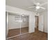 Bedroom featuring mirrored closet doors, wood-look floors, and lots of natural light at 3117 W Corrine Dr, Phoenix, AZ 85029