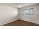 Bedroom featuring wood-look floors, a ceiling fan, and large window at 3117 W Corrine Dr, Phoenix, AZ 85029