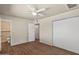 Bedroom with ceiling fan, wood-look floors, and access to a tiled en-suite bathroom at 3117 W Corrine Dr, Phoenix, AZ 85029