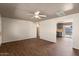 Open-concept living room featuring wood-look floors and seamless flow into adjacent kitchen at 3117 W Corrine Dr, Phoenix, AZ 85029