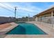 Refreshing backyard pool surrounded by concrete and white fencing, ideal for summer fun at 3117 W Corrine Dr, Phoenix, AZ 85029