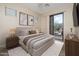 Bright bedroom with a balcony, soft carpet, and stylish decor at 3131 E Legacy Dr # 2101, Phoenix, AZ 85042