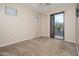 An empty bedroom with carpet and sliding door to balcony at 3131 E Legacy Dr # 2101, Phoenix, AZ 85042